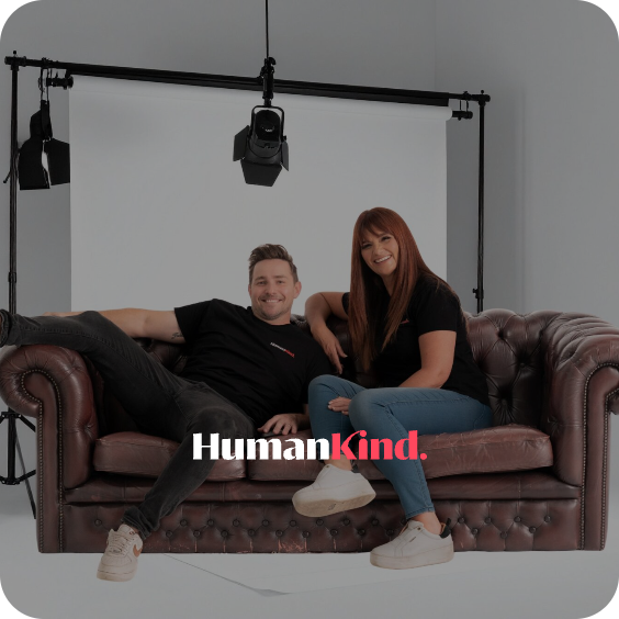 The HumanKind founders sitting on a leather couch in a photography studio